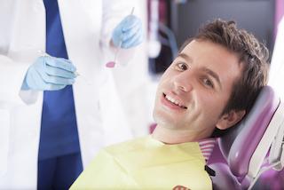 a man smiles in the dental chair | tooth colored fillings Chattanooga